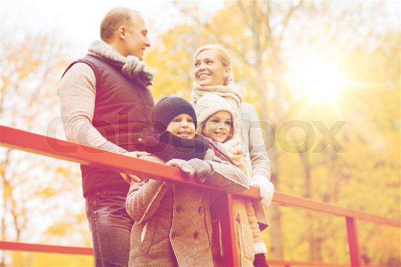 Family, childhood, season and people concept - happy family in autumn park, stock photo