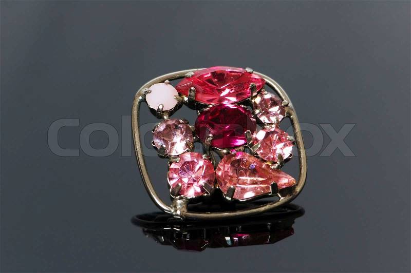 Ring with flower ornament on reflective background, stock photo