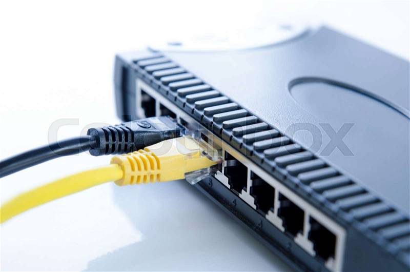 Network switch device and ethernet cables on white background, stock photo