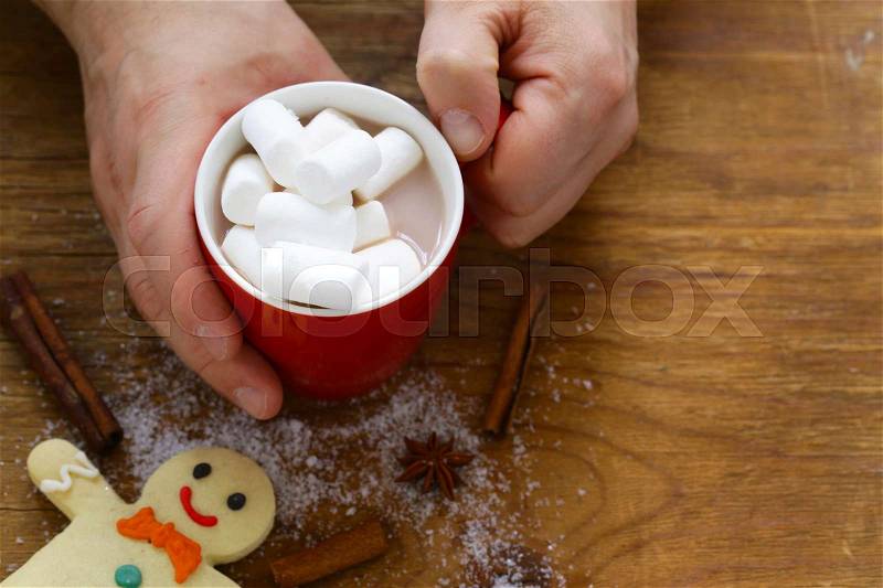 Man holding a mug hot cocoa with marshmallows, winter Christmas drink, stock photo