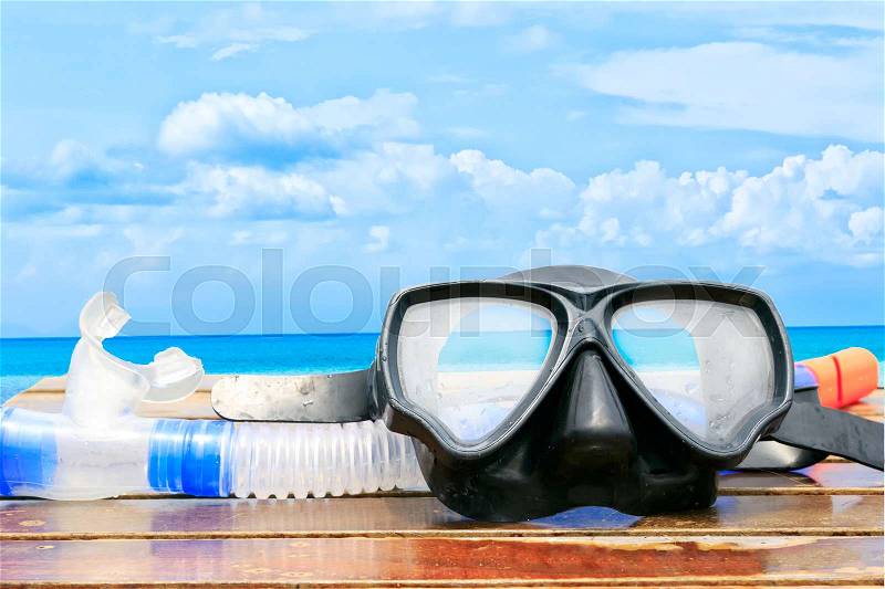Diving mask and snorkel on sea background, stock photo