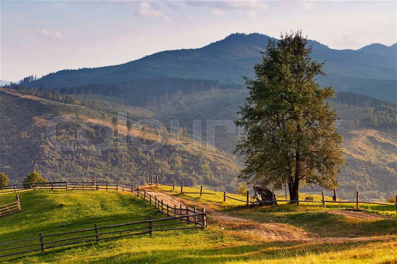 September rural scene in Carpathian mountains. Authentic village and fence , stock photo