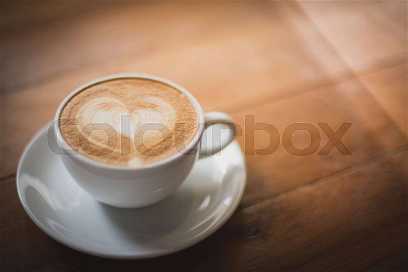 Coffee latte art make by barista in coffee shop cafe vintage color tone, stock photo