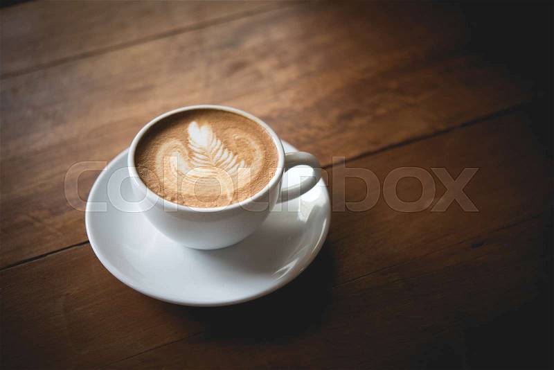 Coffee latte art make by barista in coffee shop cafe vintage color tone, stock photo