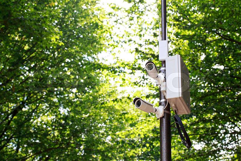 The surveillance camera on a lamp post, stock photo