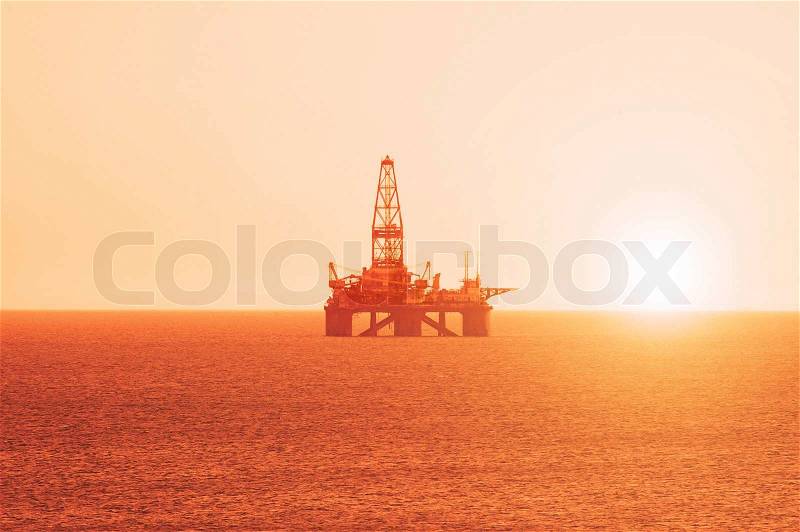 Oil platform at the sunrise, stock photo