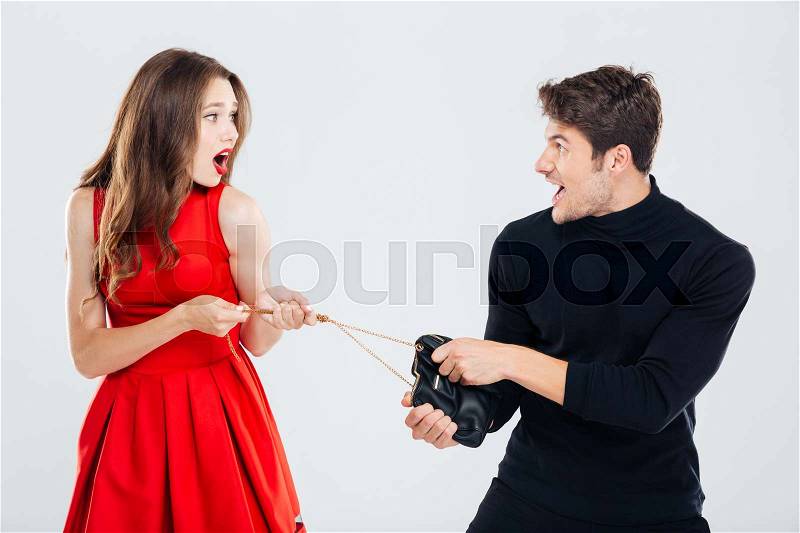 Man theif stealing young woman bag, stock photo
