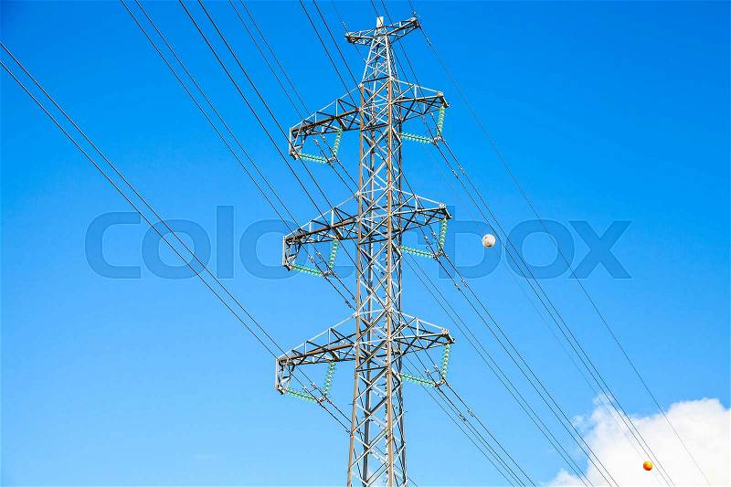 Lattice-type steel tower as a part of high-voltage line. Overhead power line details. The structure used to transmit electrical energy in electric power transmission and distribution, stock photo