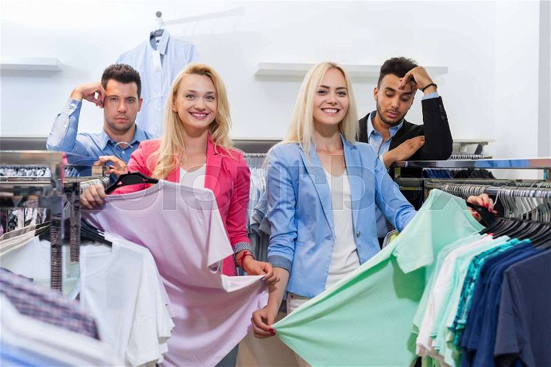 Young People Shopping, Fashion Shop Happy Smiling Woman Choosing Clothes, Tired Man Bored Customers In Retail Store, stock photo