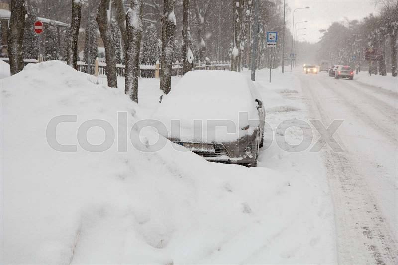 A parked car fully covered in snow, stock photo