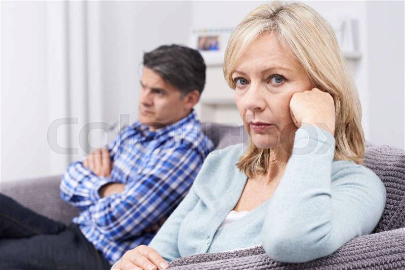 Mature Couple With Relationship Difficulties Sitting On Sofa, stock photo