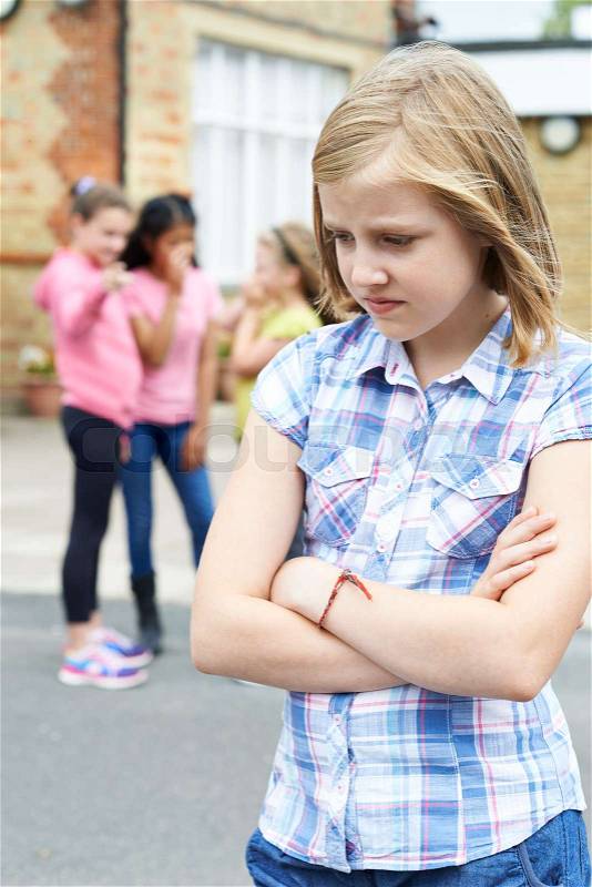 Unhappy Girl Being Gossiped About By School Friends, stock photo