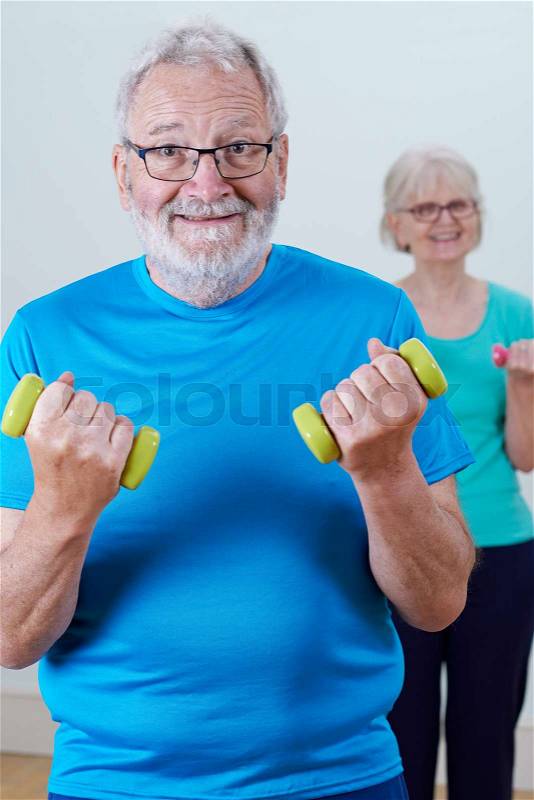 Senior Couple In Fitness Class Using Weights, stock photo