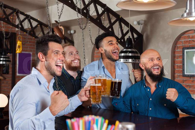 Man Group In Bar Screaming And Watching Football, Drinking Beer Hold Mugs, Mix Race Cheerful Friends Wear Shirts Meeting Pub Communicate, stock photo