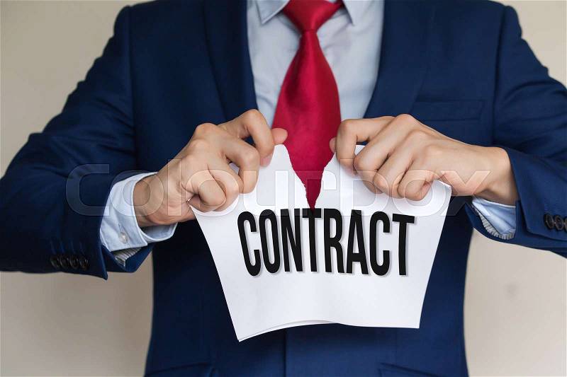 Businessman tearing CONTRACT apart on white background, stock photo
