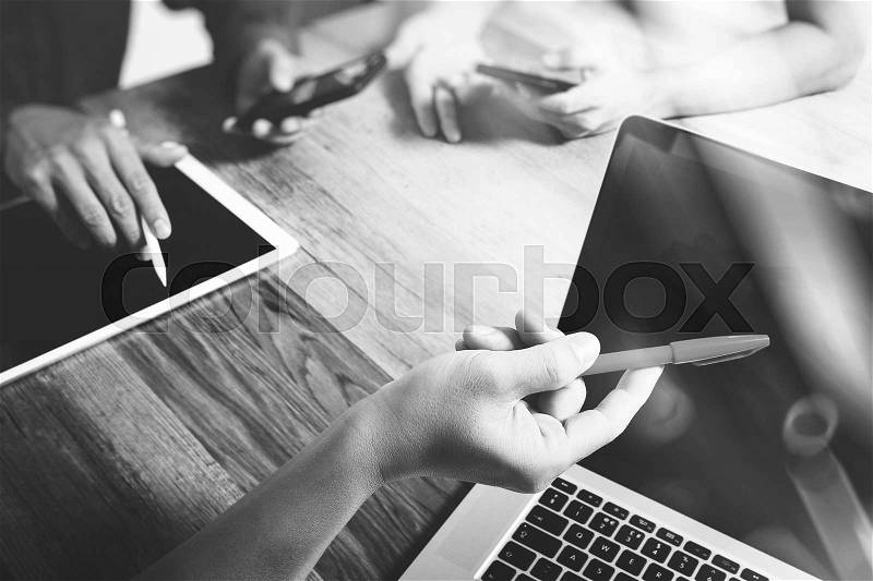 Team work concept,businessman hand attending video conference in modern office.Digital tablet laptop computer design smart phone using. Sun effects, Blurred background, stock photo