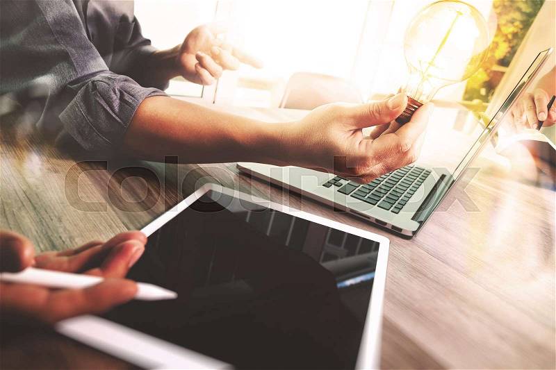 Business team meeting present. Photo professional investor working with new startup project. Finance managers meeting.Digital tablet laptop computer design smart phone using. Blurred background, Sun flare effect,Horizontal , stock photo