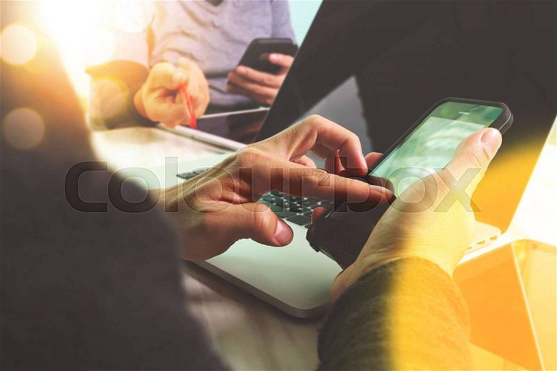 Business team meeting present. Photo professional investor working with new startup project. Finance managers meeting.Digital tablet laptop computer design smart phone using.Sun flare effect , stock photo