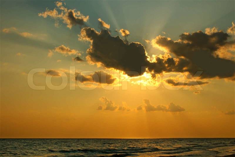 The sun has gone behind a cloud over the sea in the evening, stock photo