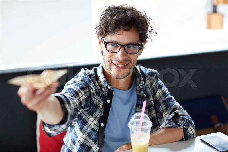 Leisure, people, payment and finance concept - happy man with cash money paying at cafe, stock photo