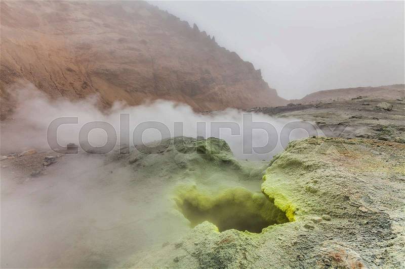 Yellow fumaroles and volcanic rocks. Kamchatka Peninsula, stock photo