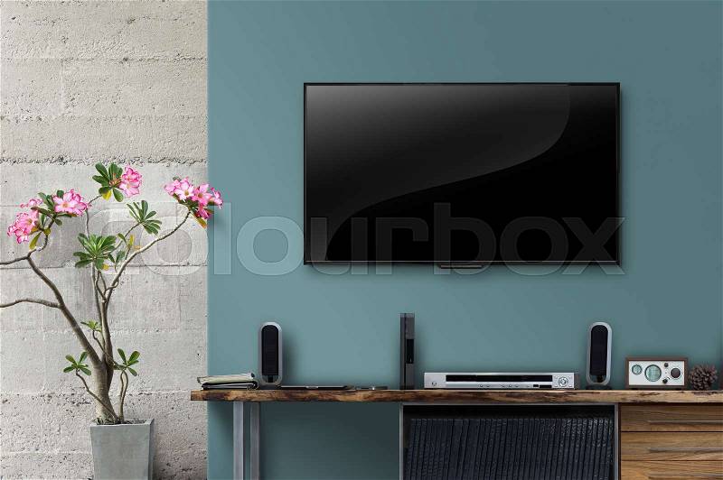 Led tv on concrete wall with wooden table in livingroom, stock photo