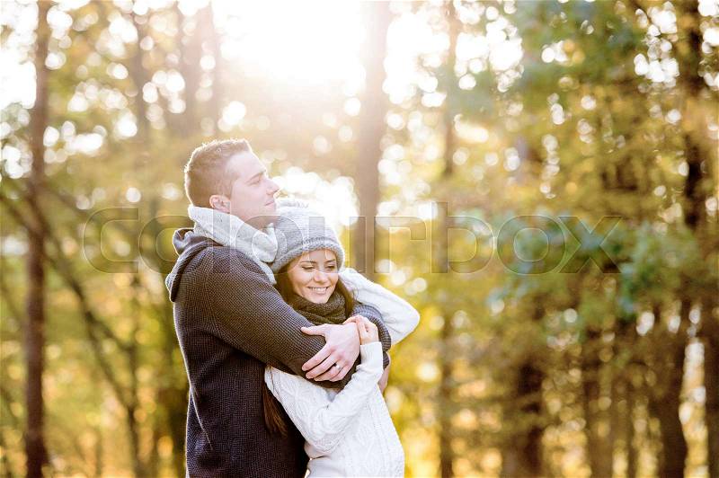 Beautiful young couple in love, hugging. Sunny autumn nature, stock photo