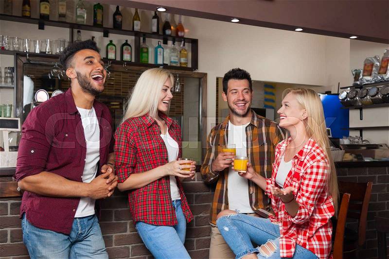 People Friends Drinking Orange Juice Talking Laughing Sitting At Bar Counter, Mix Race Man And Woman Couple Happy Smile Communication, stock photo