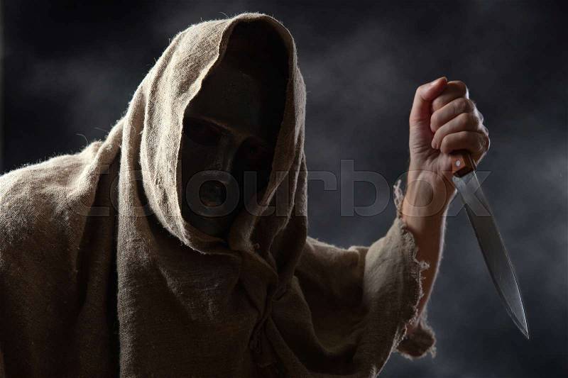 The hooded man in mask with a big knife, stock photo