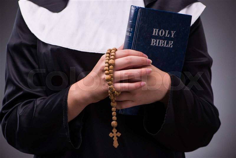 Religious nun in religion concept against dark background, stock photo