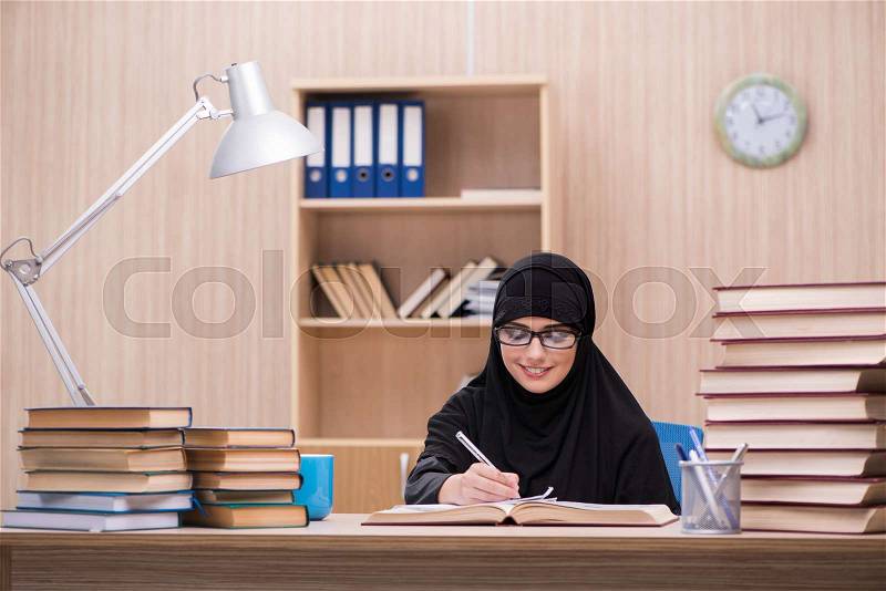 Woman muslim student preparing for exams, stock photo