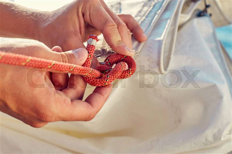 User knitting knots. Bowline knot. Process of tying Bowline process is a top view on the sail, stock photo