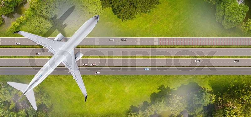 Top view of airplane flying over the roads, stock photo