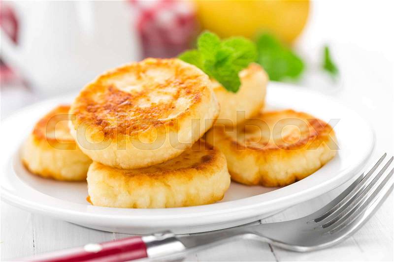 Cottage cheese pancakes, syrniki, stock photo