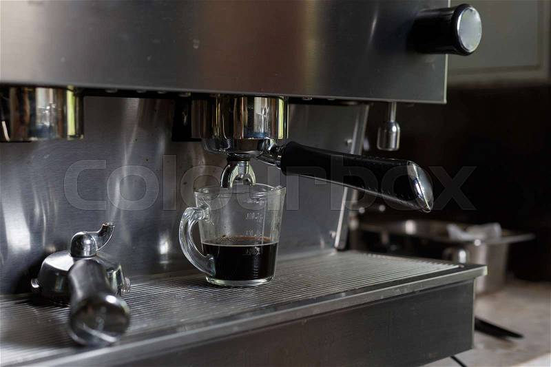 Coffee making process from automatic coffee machine in cafe shop, stock photo