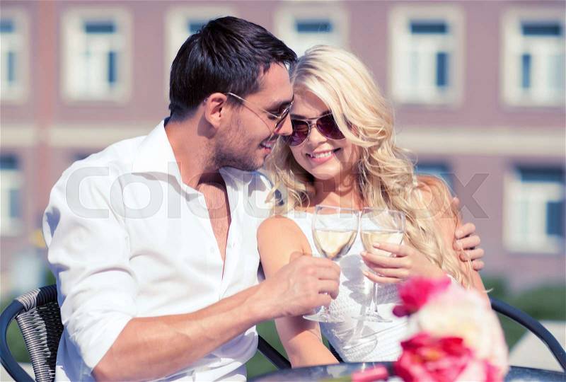 Summer holidays and dating concept - couple drinking wine in cafe in the city, stock photo