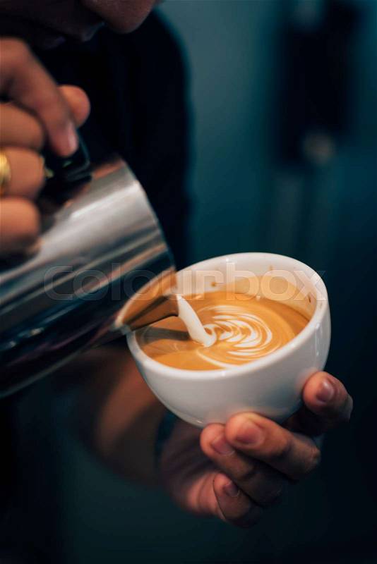 Coffee latte art in coffee shop vintage color tone, stock photo