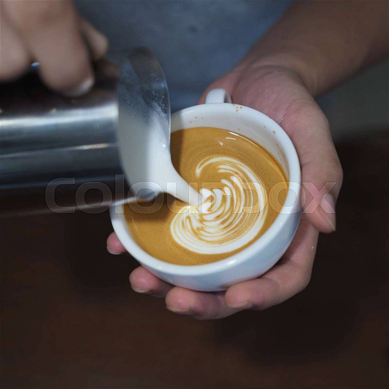 Coffee latte art in coffee shop in vintage color tone, stock photo