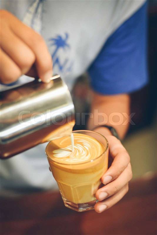Coffee latte art in coffee shop vintage color tone, stock photo
