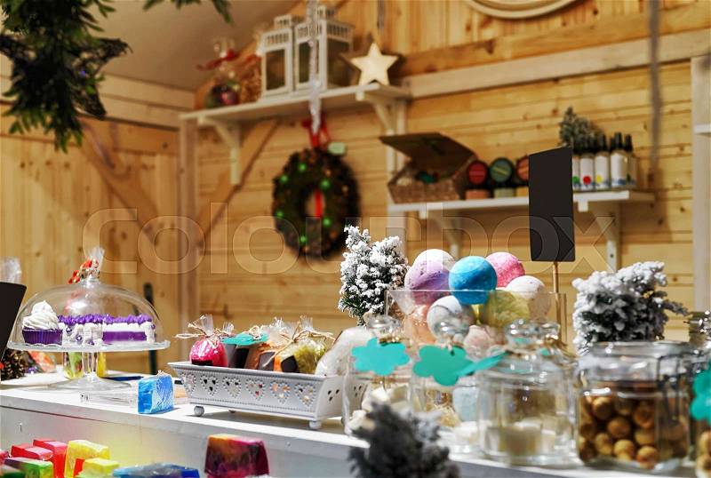 Handmade soap in different shapes at the stall in Vilnius Christmas Market. Selective focus, stock photo