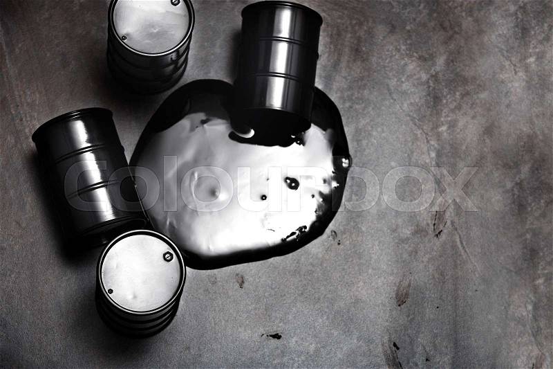High angle view on four fuel barrels with spilled oil, stock photo