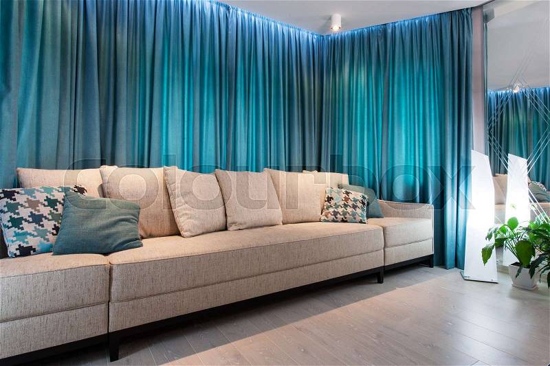 Cosy sofa in the room, light and turquoise tones, stock photo