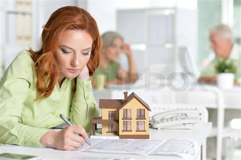 Portrait Of working Female house agent and business people In Office, stock photo