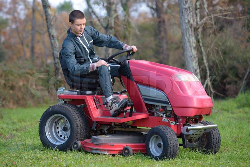 Using a ride-on mower, stock photo