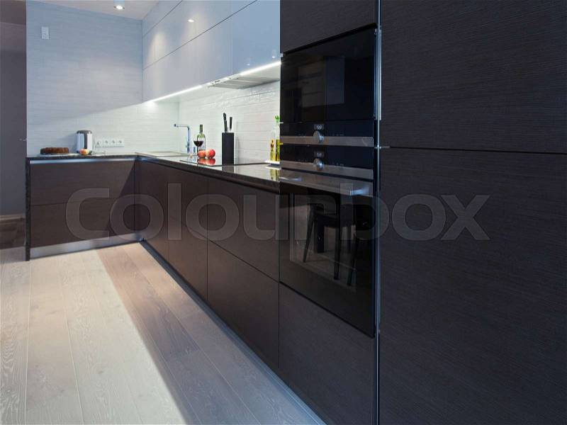 Design interior of a high tech kitchen with dark cupboard, stock photo