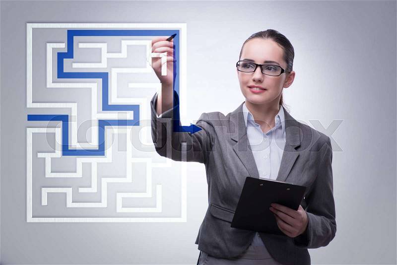 Businesswoman with maze in difficult situations concept, stock photo