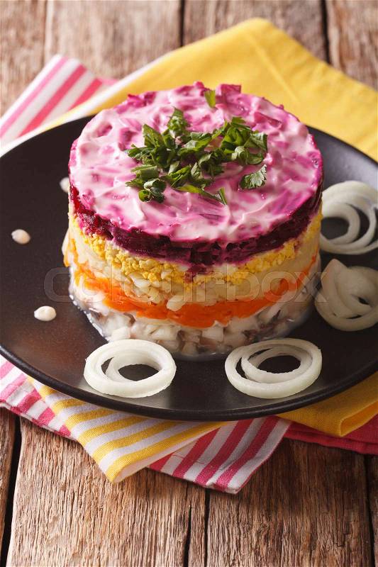 Russian food: Shuba - herring salad with vegetables close-up on the table. vertical\, stock photo