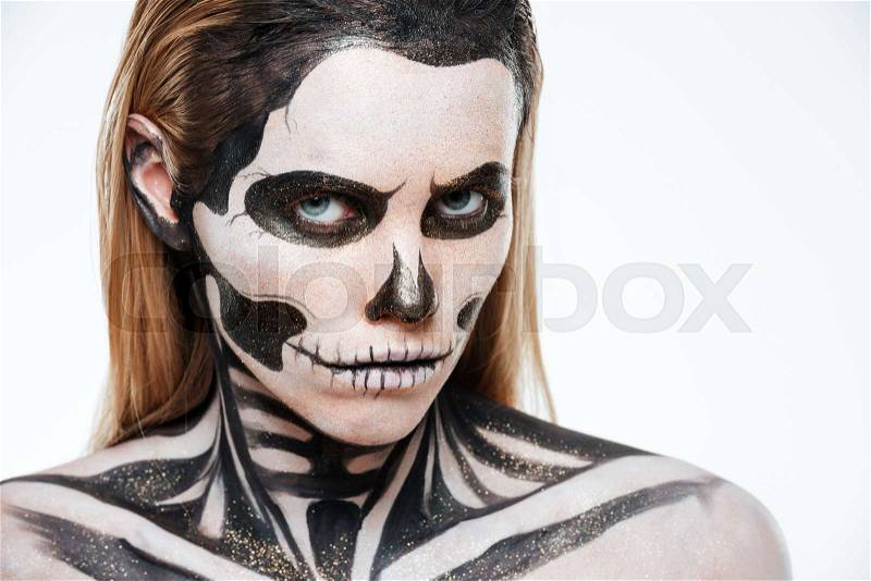 Woman with terrifying skeleton makeup over white background, stock photo