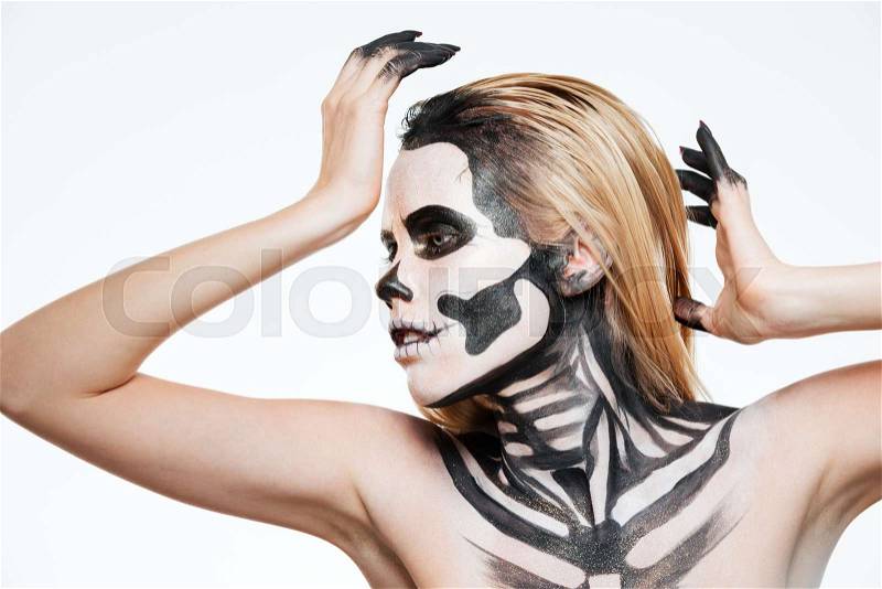 Woman with scared halloween makeup standing and posing over white background, stock photo