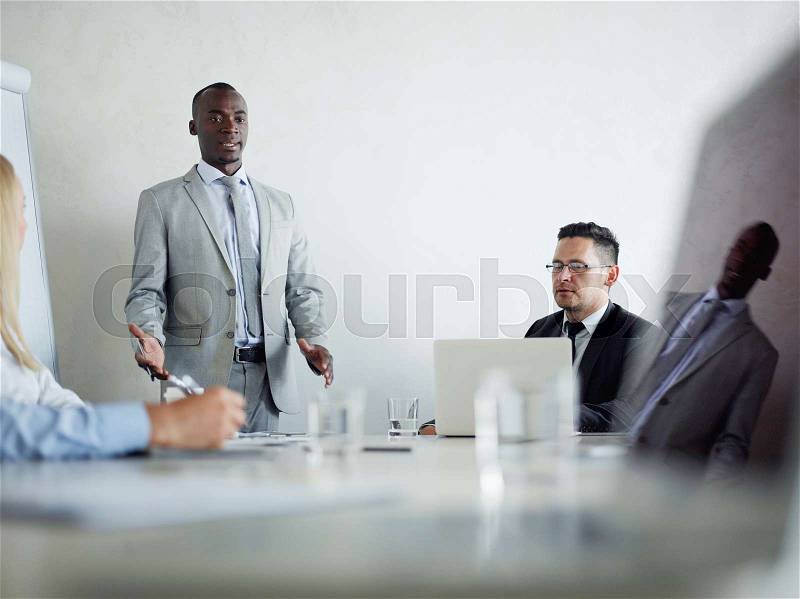 Confident teacher motivating business people at master-class, stock photo